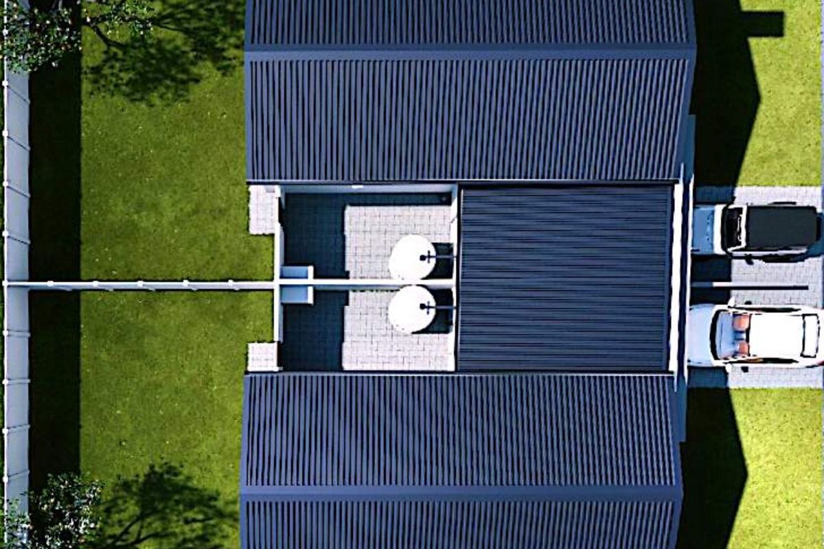 Aerial view of the property showing the roof structure, driveway, parking area, and surrounding garden space.