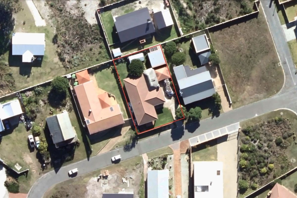 Aerial view of the residential property showing the house footprint, roof structure, and surrounding garden area within the estate.