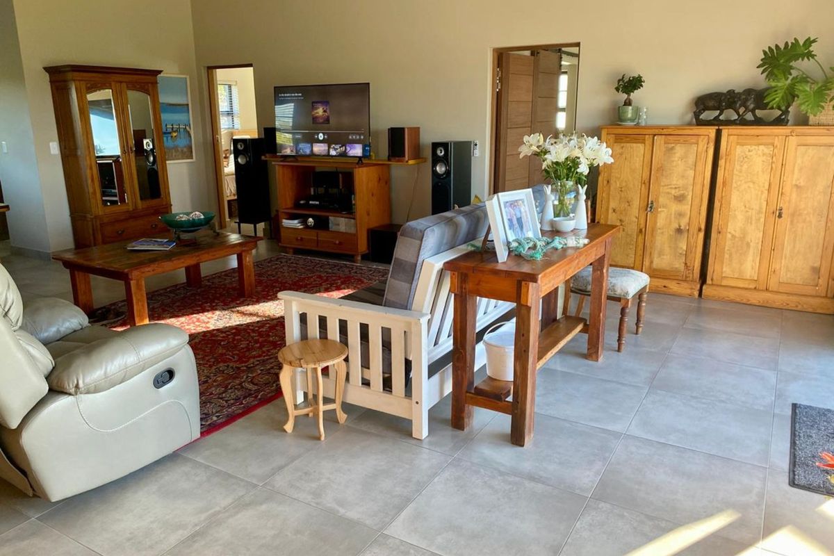 Spacious living room featuring large format floor tiles and high ceilings, providing a bright and open atmosphere.