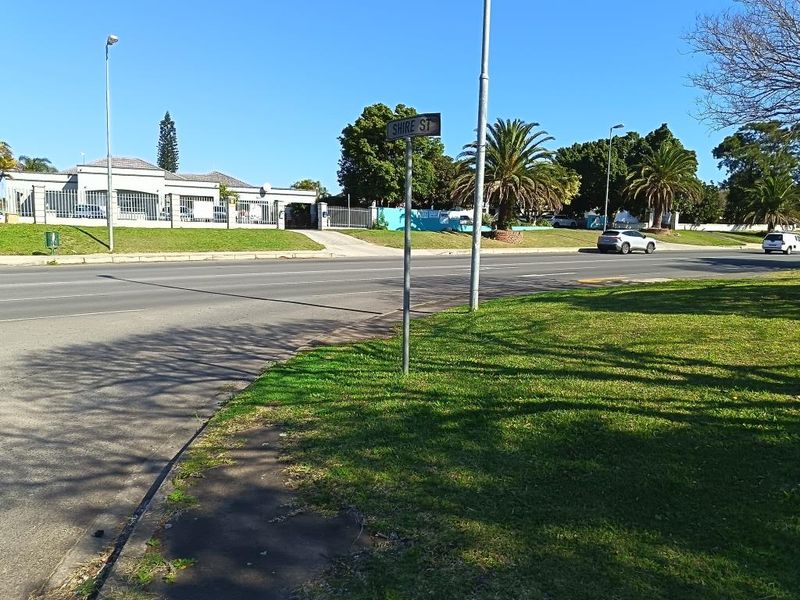 A street-level view showing the property frontage, perimeter fencing, and surrounding neighborhood infrastructure.