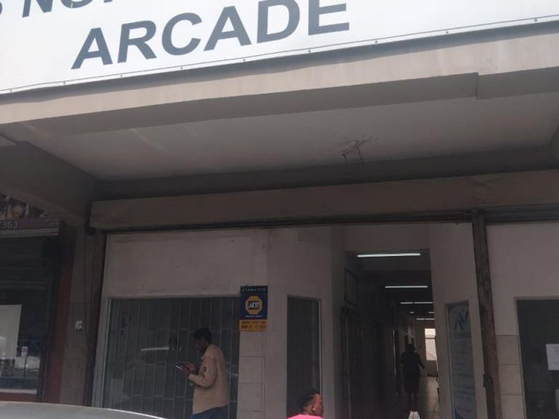 Front entrance view of North Street Arcade, featuring a covered walkway and commercial signage.