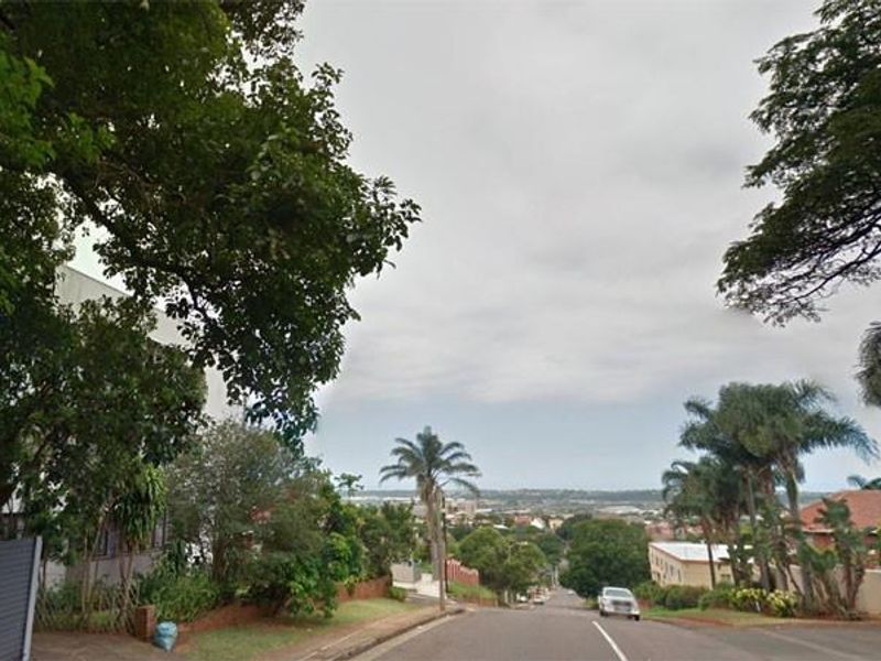 A street view showing the surrounding neighbourhood approach and local landscape.
