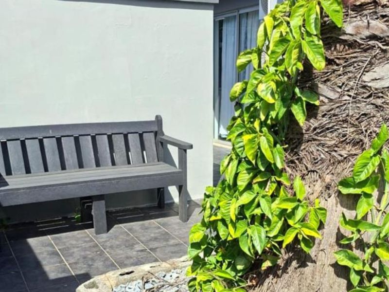 A small outdoor patio area featuring tiled flooring adjacent to the building exterior.