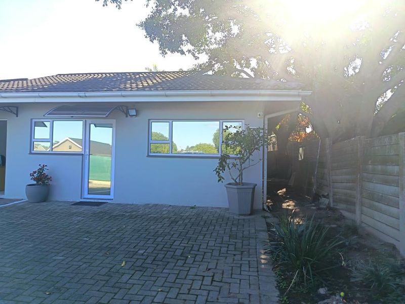 Front exterior view of a commercial property featuring a paved driveway, tiled roof, and aluminium framed windows and doors.