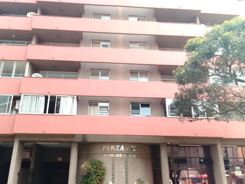 Front elevation of the Penzance apartment building, featuring multiple levels with private balconies and standard window configurations.