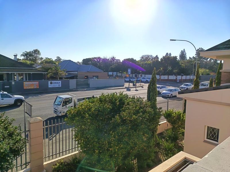 Elevated street view showing the property frontage, perimeter fencing, and surrounding neighbourhood access.
