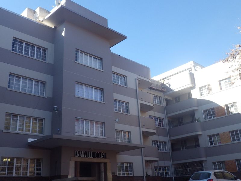 Exterior view of Granville Court, a multi-story apartment building featuring a modern facade with balconies and casement windows.