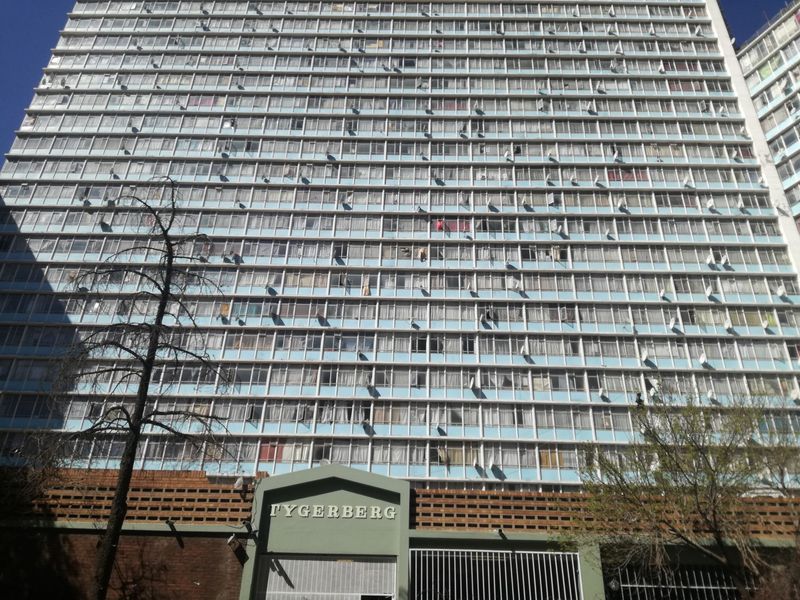 Front elevation view of the Tygerberg apartment building, showcasing the multi-story residential facade and ground-level security entrance.