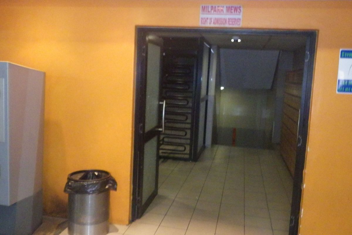 Entrance area of the building featuring tiled flooring and access to an internal staircase.