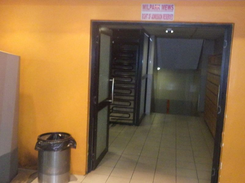 Entrance area of the building featuring tiled flooring and access to an internal staircase.